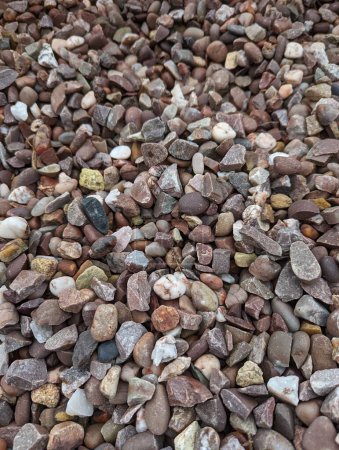 This close-up photo showcases a pile of rocks, highlighting their texture, shape, and arrangement.gravel,closeup,close,pink,stone,rock,rocks,pile,close-up,texture,shape,arrangement,stones,boulders,heap,ground,rugged,earthy,mound,pebbles,minerals,sedi