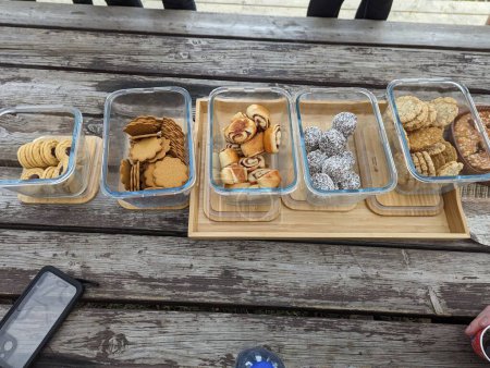 A variety of delicious fika snacks arranged on wooden trays, showcasing Stockholm's culture of enjoying small snacks and coffee in Sweden