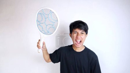 young Asian man using mosquito swatter, electric net racket on isolated white background