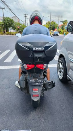 Foto de Motorcycle with a luggage box installed on the back. so much more luggage. Bali - Indonesia ; December 11, 2022. - Imagen libre de derechos