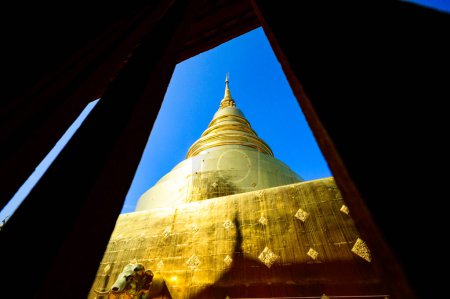 Photo for Ancient golden pagoda in window frame at Wat Phra Singh temple, Chiang Mai province. - Royalty Free Image