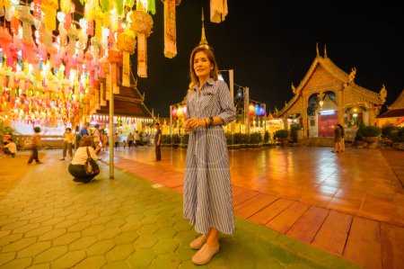 Photo for Woman Tourist in Lamphun Lantern Festival at Night, Lamphun Thailand. - Royalty Free Image