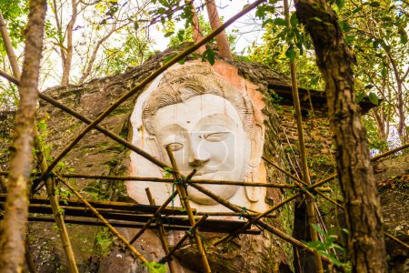 Photo for Carving Buddha art on rock in Huai Pha Kiang temple, Thailand. - Royalty Free Image