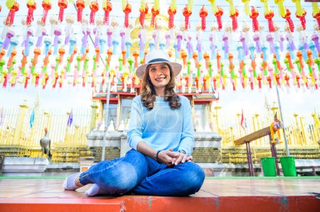 Photo for Asian female tourist with Lanna style background in Lamphun province, Thailand. - Royalty Free Image
