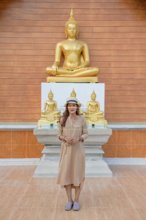 Asian Woman with Buddha Statue Background at Si Mongkol Temple, Nan Province.