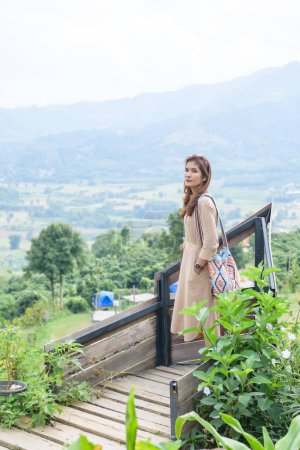 Asian Woman with Mountain View Background at Phu Langka Viewpoint, Phayao Province.