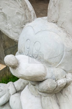 LAMPHUN, THAILAND - July 12, 2015 : Mickey mouse statue on grass floor, Thailand.