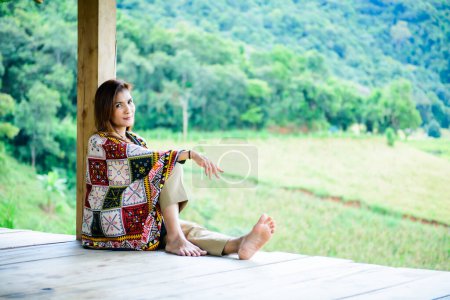Asian Woman in Thai Native Pavilion with Rice Field Background at Pa Bong Piang Rice Terraces, Chiangmai Province.
