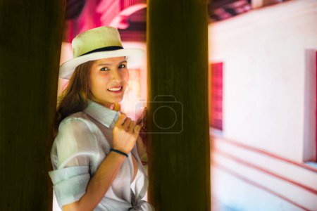 Asian female tourist with Lanna style background, Thailand.