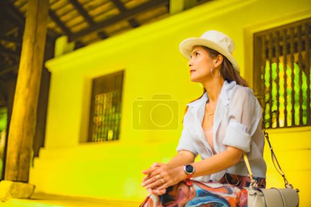 Asian female tourist with Lanna style background, Thailand.