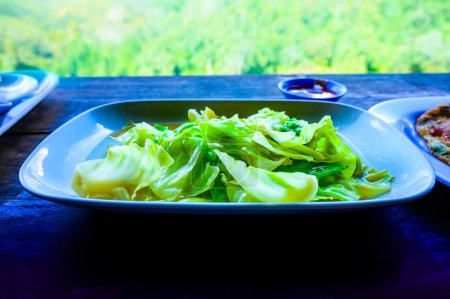 Photo for Stir fried cabbage with fish sauce amidst the refreshing mountain atmosphere at Chiang Mai Province, Thailand. - Royalty Free Image