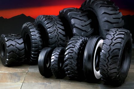 Photo for Many tires shown in a line up, ready to be used on cars, trucks, tractors, and more - Royalty Free Image
