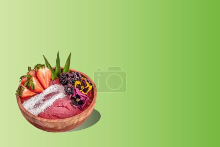 Photo for Acai bowl with colorful gradient background. Summer acai smoothie wooden bowl with strawberries, blackberries. - Royalty Free Image
