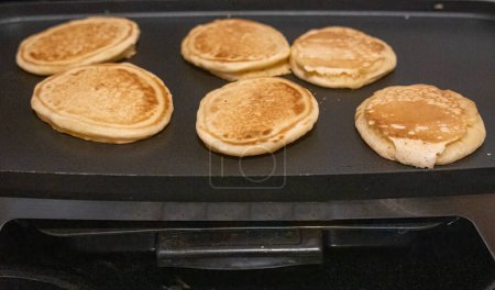 Side view of pancakes on kitchen table.