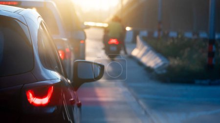 Photo for Abstract and blurred rear side of car with speed light of brake. Lines and traffic jams in the morning. Bright light shines brightly in the morning. Beside road with concrete bridge. - Royalty Free Image