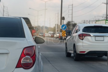 Photo for Rear side view of white car with tail lights. Environment of car in the day time. Rush hour in the city. Traffic jam on the road in Thailand. - Royalty Free Image