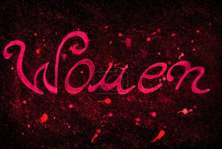 Photo for The word Woman in pink isolated on a black textured background. Handwritten cursive font. The background consists of pink and red splashes, drops on black. Chaotic drops of different shades. - Royalty Free Image