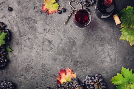 Photo for Wine with grapes, leaves and corks on dark background, copyspace, flat lay - Royalty Free Image