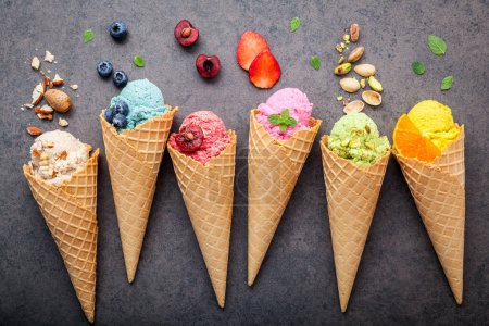 Photo for Various of ice cream flavor in cones setup on dark stone background . - Royalty Free Image