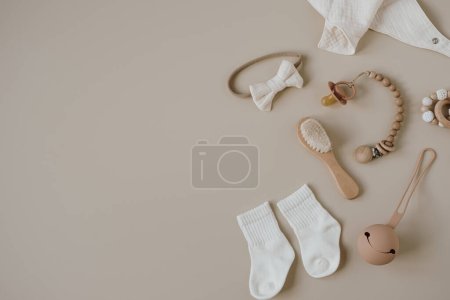 Téléchargez les photos : Flatlay esthétique scandinave accessoires de soins pour bébés nouveau-nés, collage jouets sur fond neutre beige pastel. Ensemble élégant et tendance pour bébé de luxe. Vue du dessus - en image libre de droit