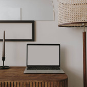 Laptop computer with blank screen on table with candles, floor lamp. Aesthetic boho styled home interior design template with mockup copy space. Online store, blog, social media, shop branding Poster #620992136