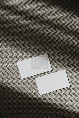Photo for Flatlay of blank paper cards with sunlight shadows on seamless classic fabric pattern background. Business template. Top view, flat lay minimalist aesthetic luxury bohemian business branding concept - Royalty Free Image