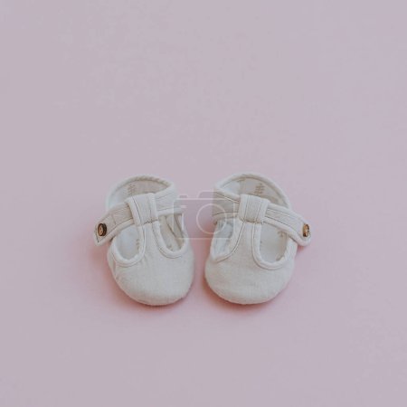 Photo for Newborn children's mini sandal shoes. Baby shoes on pastel pink background. Fashion Scandinavian children's clothes. Flat lay, top view - Royalty Free Image