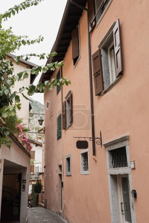 Photo for Old historic Italian architecture. Traditional European village rustic buildings. Flowers, wooden windows, shutters and pastel walls. Aesthetic summer vacation travel background - Royalty Free Image