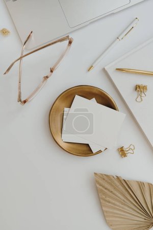 Photo for Flatlay laptop computer, paper card sheet with copy space, glasses and office stuff. Top view minimalist aesthetic work at home, business concept with blank mockup copyspace - Royalty Free Image