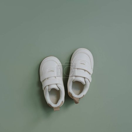 Photo for White sneaker shoes for child baby. Flat lay of nordic Scandinavian fashion children's wearing. Aesthetic neutral pastel colour - Royalty Free Image
