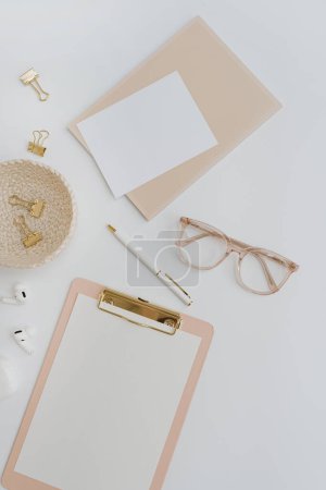 Photo for Clipboard notepad with blank mockup copy space template. Aesthetic stylish golden female office stationery accessories on pastel background. Flatlay, top view - Royalty Free Image