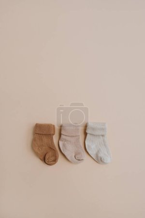 Photo for Pastel cozy eco friendly stylish Scandinavian toddle, newborn baby socks. Online fashion store, online shopping branding concept. Neutral pastel colours - Royalty Free Image