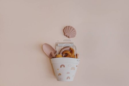 Photo for Set of summer kids baby toy tools to play with water and sand. Toy bucket, shovel, sand molds. Aesthetic neutral pastel beige colors - Royalty Free Image