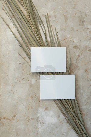 Photo for Flatlay of blank paper cards, dry palm leaf stem on marble background. Business template. Top view, flat lay minimalist aesthetic luxury bohemian business branding concept - Royalty Free Image