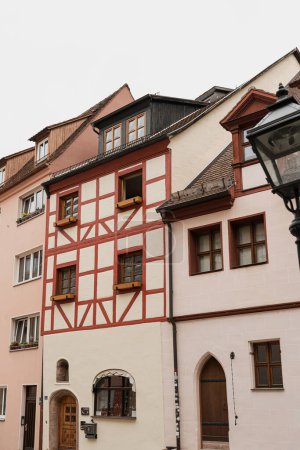 Photo for Old historic architecture in Nuremberg, Germany. Traditional European old town buildings with wooden windows, shutters and colourful pastel walls. Aesthetic summer vacation, tourism background - Royalty Free Image