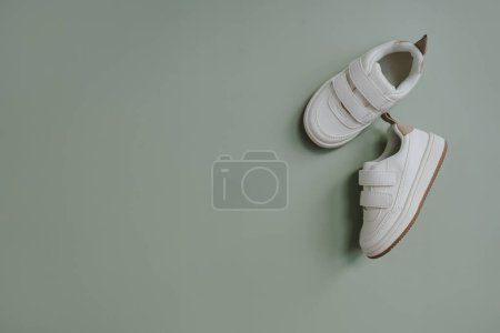 Photo for White mini sneaker shoes for baby, child. Flatlay, top view - Royalty Free Image