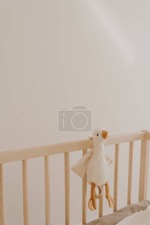 Photo for Children's toy duck on crib. Baby minimal interior design decoration - Royalty Free Image
