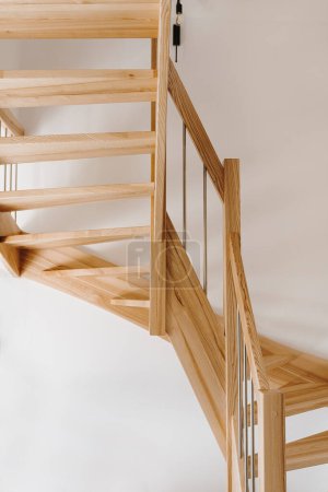 Photo for Wooden staircase over white wall - Royalty Free Image