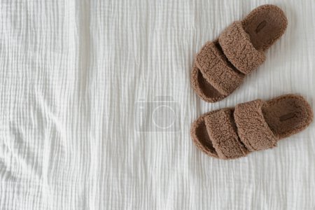 Photo for Soft fluffy slippers on white muslin cloth. Flat lay, top view minimal fashion concept - Royalty Free Image
