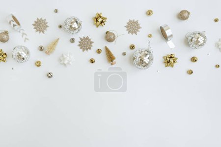 Photo for Christmas, New Year holidays composition. Gold baubles balls, stars on white background. Christmas tree decorations. Flat lay, top view festive pattern with blank copy space - Royalty Free Image