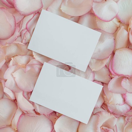 Photo for Blank branding paper card sheet with mockup copy space and elegant pink rose flower petals. Aesthetic flowers composition - Royalty Free Image