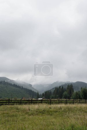 Foto de Picturesque view of mountain hill, forest, sky and clouds. Scenic nature landscape. Summer vacation travel - Imagen libre de derechos