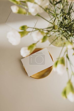 Photo for Blank paper sheet card with mockup copy space and flowers. Aesthetic sunlight shadows. Minimal business brand template - Royalty Free Image