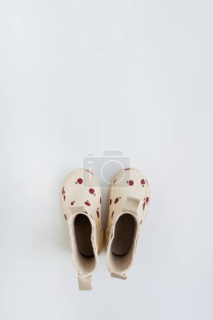 Photo for Baby's rubber rain boots on white background. Fashion baby outfit for rainy weather. Copy space - Royalty Free Image