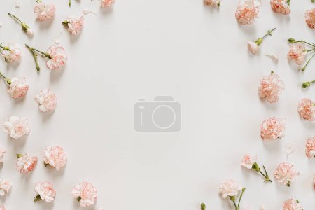 Photo for Minimal floral styled concept. Pink carnation flowers on white background with copy space. Creative wedding invitation template. Flat lay, top view - Royalty Free Image