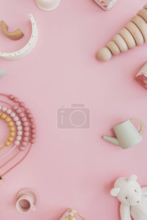 Photo for Set of stylish natural Scandinavian baby kids toys on pastel pink background with blank copy space for mock up. Baby girl stuff for playing and education. Flat lay, top view - Royalty Free Image
