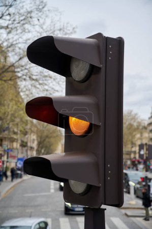 Traffic light turning orange, close-up, Paris