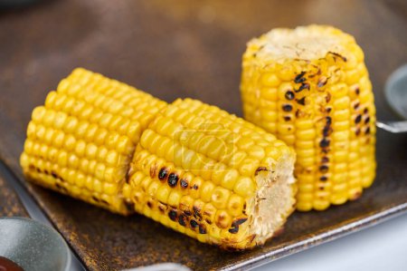 pieces of baked corn on the edge of a rectangular plate.
