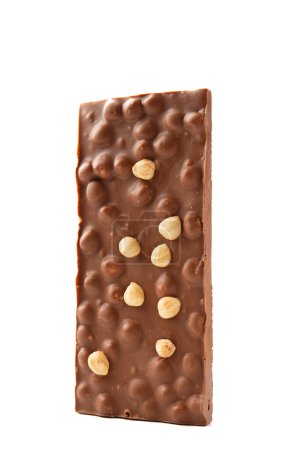 Foto de Milk chocolate with hazelnuts on a white background close-up. A whole bar of craft chocolate with nuts vertically on isolation. - Imagen libre de derechos