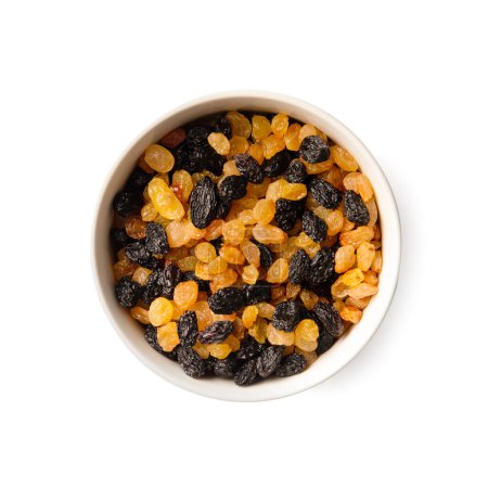 Foto de White and dark raisins in a bowl on a white background top view. Dry grapes in a ceramic plate isolated. Clay bowl with colorful raisins. - Imagen libre de derechos